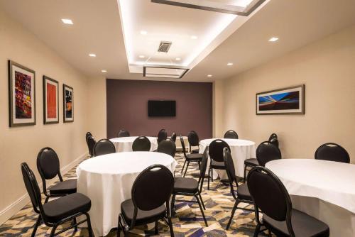a conference room with tables and chairs and a screen at Homewood Suites Midtown Manhattan Times Square South in New York