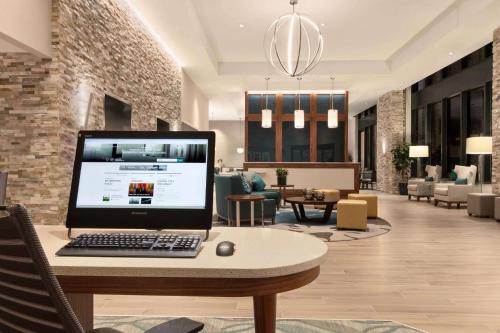 a laptop computer sitting on a table in a lobby at Homewood Suites by Hilton Washington DC Convention Center in Washington