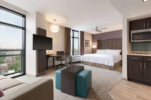 a hotel room with a bed and a desk at Homewood Suites by Hilton Washington DC Convention Center in Washington