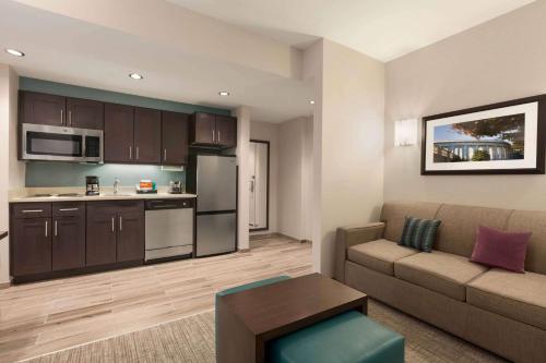 a living room with a couch and a kitchen at Homewood Suites by Hilton Washington DC Convention Center in Washington