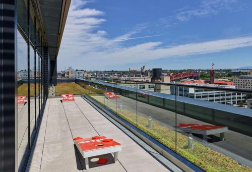 a balcony with a table and benches on a building at Canopy by Hilton Portland Pearl District in Portland