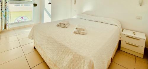 a bed with two towels on it in a room at Crisp Modern House in Maspalomas