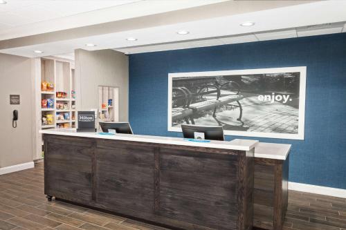 an office lobby with a reception desk with chairs at Hampton Inn Kennebunk Kennebunkport Me in Kennebunk