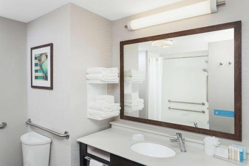 a bathroom with a sink and a mirror at Hampton Inn Kennebunk Kennebunkport Me in Kennebunk