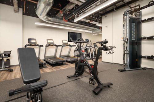 a gym with treadmills and exercise bikes in it at Motto by Hilton Philadelphia Rittenhouse Square in Philadelphia