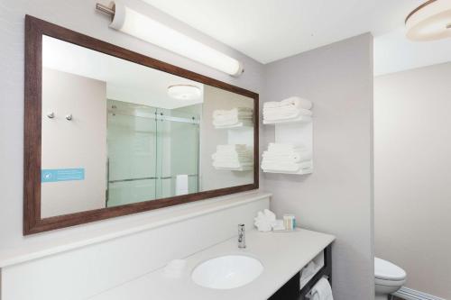 a bathroom with a sink and a mirror at Hampton Inn Kennebunk Kennebunkport Me in Kennebunk