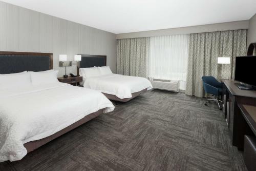 a hotel room with two beds and a desk at Hampton Inn Kennebunk Kennebunkport Me in Kennebunk