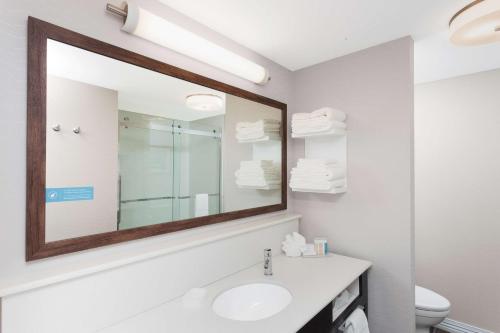 a bathroom with a sink and a mirror at Hampton Inn Kennebunk Kennebunkport Me in Kennebunk
