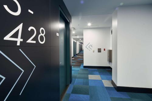 a hallway of an office with a wall with the number at Motto by Hilton Philadelphia Rittenhouse Square in Philadelphia
