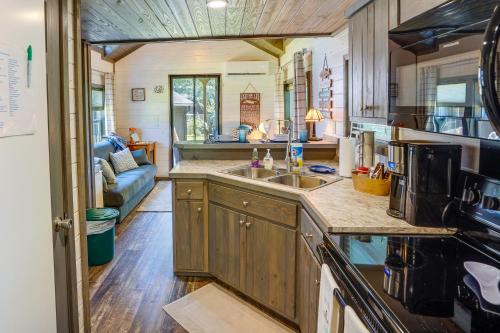 a kitchen and living room in a tiny house at Mayfield Tiny Home with Porch, Walk to Beaches! in Benson