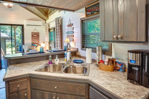 a kitchen with a sink and a counter top at Mayfield Tiny Home with Porch, Walk to Beaches! in Benson