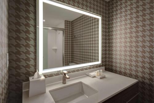 a bathroom with a sink and a large mirror at Home2 Suites by Hilton Troy in Troy