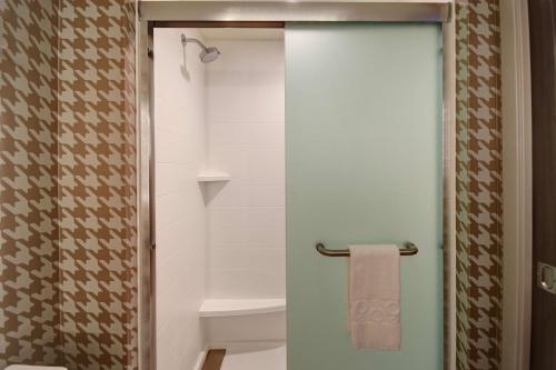 a bathroom with a shower with a glass door at Home2 Suites by Hilton Troy in Troy