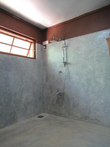 a bathroom with a shower with a glass door at The Rezt in Ella