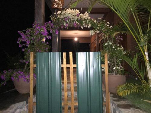 a entrance to a building with purple and white flowers at The Rezt in Ella
