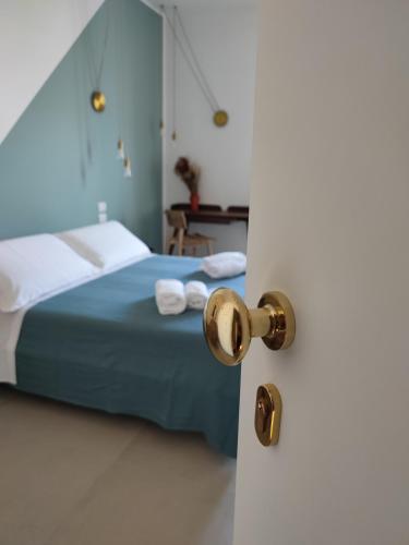a bedroom with a blue bed with towels on it at Sfumature D'aMare in Monopoli