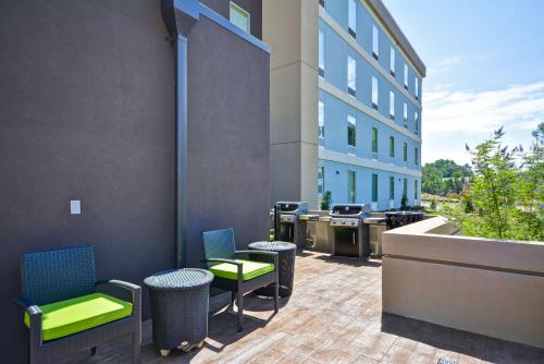 a patio with chairs and tables in front of a building at Home2 Suites By Hilton Rock Hill in Rock Hill