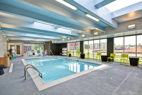 a swimming pool in a large room with windows at Home2 Suites By Hilton Rock Hill in Rock Hill
