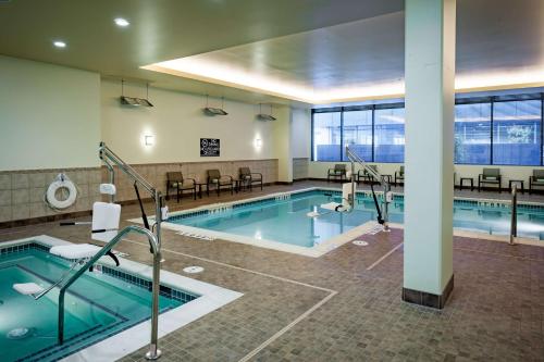a pool in a building with a swimming pool at Hilton Garden Inn Seattle Downtown in Seattle
