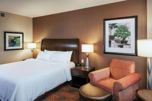 a hotel room with a bed and a chair at Hilton Garden Inn Seattle Downtown in Seattle