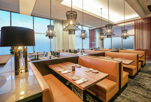a restaurant with couches and tables and windows at Hilton Garden Inn Seattle Downtown in Seattle