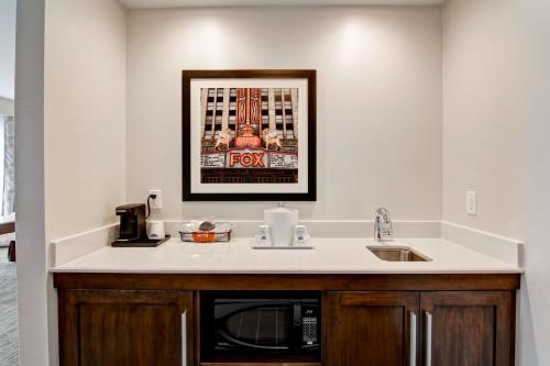 a kitchen with a sink and a microwave at Hampton Inn & Suites Detroit/Troy in Clawson