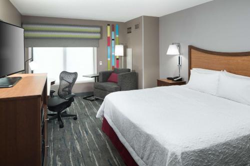 a hotel room with a bed and a desk at Hampton Inn & Suites Chicago North Shore in Skokie
