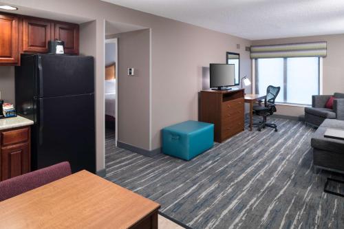 a hotel room with a kitchen and a living room at Hampton Inn & Suites Chicago North Shore in Skokie