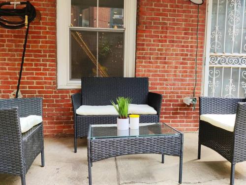 a patio with three chairs and a table and a window at Charming 1BDR In Central Rittenhouse Square With Patio Hosted by StayRafa in Philadelphia