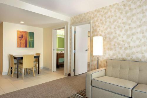 a living room with a couch and a table at Home2 Suites by Hilton Milwaukee Airport in Milwaukee