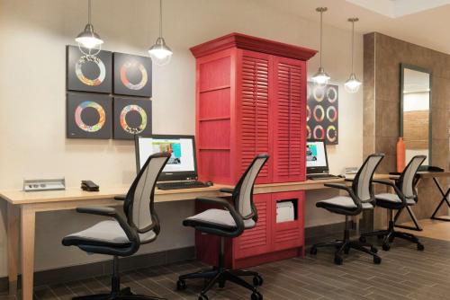 an office with a red desk with chairs and a computer at Home2 Suites by Hilton Milwaukee Airport in Milwaukee