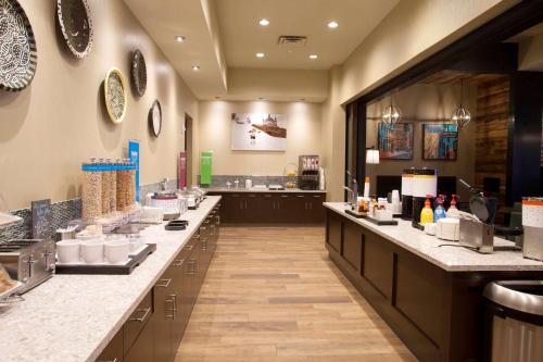a restaurant with a long counter in a room at Hampton Inn & Suites St. Paul Downtown in Saint Paul