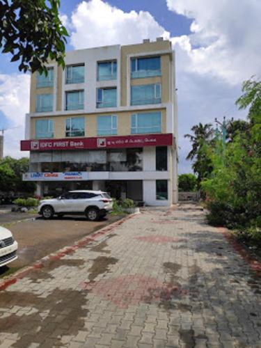a building with a car parked in front of it at DSquare omr BY K Hotels in Chennai