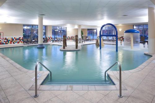 a large indoor swimming pool in a building at Hampton Inn & Suites Oklahoma City-Bricktown in Oklahoma City