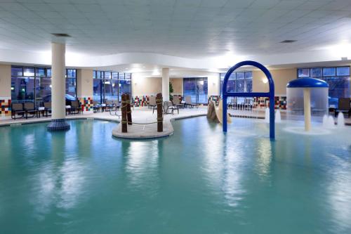 a swimming pool in a building with a water park at Hampton Inn & Suites Oklahoma City-Bricktown in Oklahoma City
