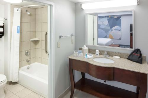 a bathroom with a sink and a tub and a toilet at Hampton Inn & Suites Oklahoma City-Bricktown in Oklahoma City