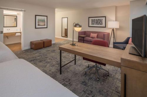 a hotel room with a bed and a desk with a television at Hampton Inn And Suites By Hilton Portland-Pearl District in Portland