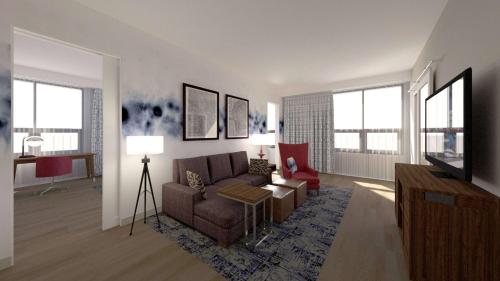 a living room with a couch and a tv at Hampton Inn And Suites By Hilton Portland-Pearl District in Portland
