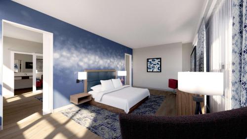 a bedroom with a white bed and a blue wall at Hampton Inn And Suites By Hilton Portland-Pearl District in Portland