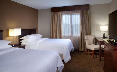 a hotel room with two beds and a window at Embassy Suites by Hilton Austin Arboretum in Austin