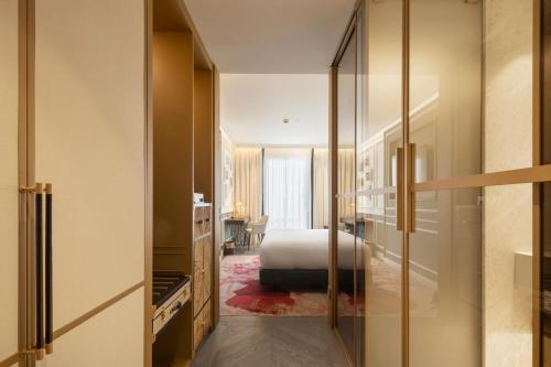 um quarto com uma cama e um quarto com uma secretária em The Emerald House Lisbon - Curio Collection By Hilton em Lisboa