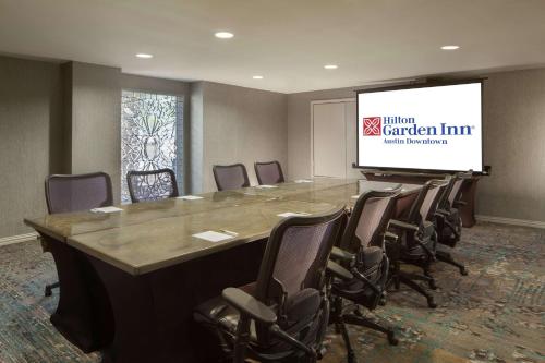 a conference room with a large table and chairs at Hilton Garden Inn Austin Downtown in Austin