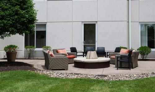 a patio with couches and chairs in front of a building at Hilton Garden Inn BWI Airport in Linthicum Heights