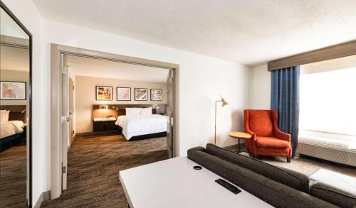 a hotel room with a couch and a bed at Hilton Garden Inn BWI Airport in Linthicum Heights