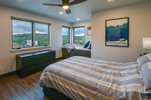 a bedroom with a bed and two windows at Steamboat Springs Apt with Views, 15 Mi to Skiing! in Steamboat Springs