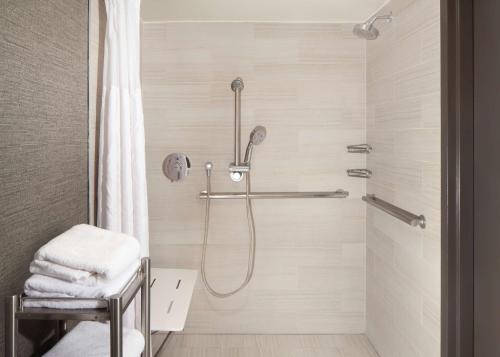 a bathroom with a shower with a shower curtain at Hilton Parsippany in Parsippany