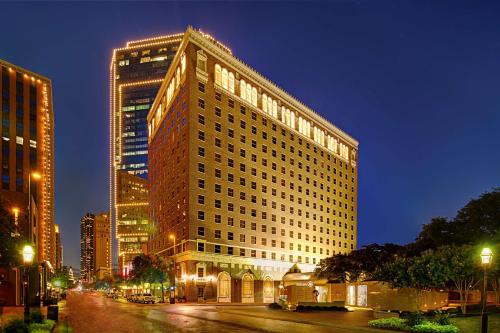 a large building on a city street at night at Hilton Fort Worth in Fort Worth