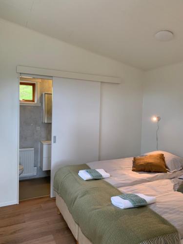 a bedroom with a bed with two pillows on it at Skammidalur cottages in Vík