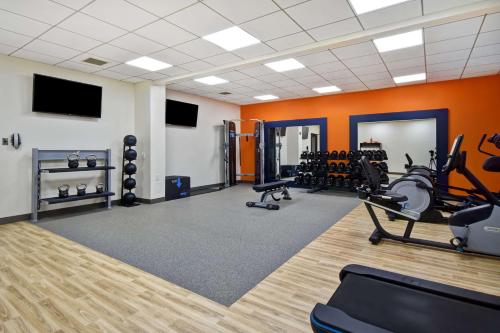 a gym with treadmills and exercise equipment in a room at Hampton Inn NY-JFK in Queens