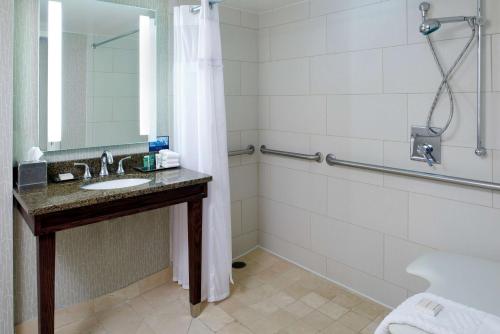 a bathroom with a sink and a shower at Hilton Minneapolis-St Paul Airport in Bloomington